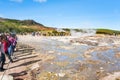 Tourists wait eruption near Strokkur geyser Royalty Free Stock Photo