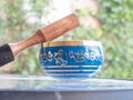 Haulerwijk - march 07 2020: Haulerwijk, The Netherlands. blue and golden indian singing bowl made of seven metals with a