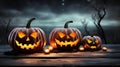 Haunted Harvest Trio Three Spooky Halloween Pumpkins with Evil Faces on Wooden Bench, Table, and Misty Gray Coastal Night Royalty Free Stock Photo