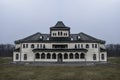 Haunted house with dark horror atmosphere and full moon. Creepy old mansion at night. Spooky scene like in frightening movies. Sty Royalty Free Stock Photo