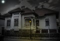 Haunted house with dark horror atmosphere and full moon. Creepy old mansion at night. Spooky scene like in frightening movies. Sty Royalty Free Stock Photo