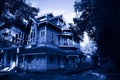 Haunted House with Dark Horror Atmosphere. Scary colonial cottage in mysterious forestland Royalty Free Stock Photo