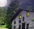 Haunted house in the woods, with moon in the sky. Royalty Free Stock Photo