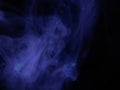 Haunting ghostly apparitions pushing through a dark Blue wall of smoke