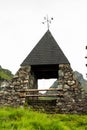 Haus im Ennstal, Steiermark/Austria - June 27 2018: stone build monument with bells on one of the peaks of the Hauser Kaibling