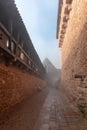 Haut Koenigsbourg fortified castle in the morning mist. Drawbridges, weapons room, keep and cannons, mountain fortress. Royalty Free Stock Photo