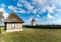 View of the historic windmill Moulin de Pierre and miller`s house in Hauville in Normandy Royalty Free Stock Photo