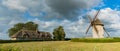 View of the historic windmill Moulin de Pierre and miller`s house in Hauville in Normandy