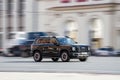 Haval Dargo drive on highway. Haval Big Dog crossover driving in city. Fast moving black SUV on urban road, front side view Royalty Free Stock Photo