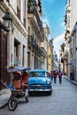 Havana, classic car in small street with view to Capitolio, Cuba