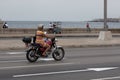 Havana, Cuba - April 13, 2017: A woman drives a motorcycle along the Malecon in Havana