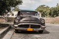 Havana, Cuba - Aug. 2017: Old and rusty car Oldsmobile - Taxi in the surburb of Havana