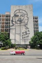 HAVANA, CUBA, AUG 16, 2016: Vintage car drives in front of iconic Che Guevara`s mural at Revolution Square