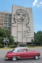 Havana, Cuba, August 16, 2016: Vintage car drives in front of iconic iron mural at the Plaza de la Revolucion Revolution Square