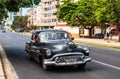 Black classic American car on the streets of Havana, tourist attraction Royalty Free Stock Photo