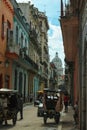 04/04/2016: Havana, Cuba: A busy street in the socialist country capital with Rikshas and the Capitol in the background