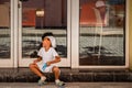 Havana / Cuba - 04.15.2015: Cute afro cuban kid playing on the street, laughing and having fun while another kid playing a phone Royalty Free Stock Photo