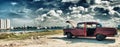 HAVANA, CUBA- DEC 12, 2016: panoramic view of havana and malecon with old american car parked whit engine ploblem