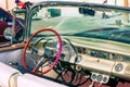 HAVANA, CUBA - DECEMBER 10, 2019: Havana Cuba Classic Cars. Typcal Havana urban scene with colorful buildings and old cars Royalty Free Stock Photo