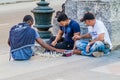 HAVANA, CUBA - FEB 21, 2016: Young locals are playing chess on a pedestrian zone of Paseo de Marti Prado avenue in