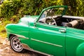 Green classic American car on the streets of Havana, tourist attraction Royalty Free Stock Photo