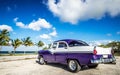 American blue white 1956 vintage car parked direct on the beach in Havana Cuba - Serie Cuba Royalty Free Stock Photo