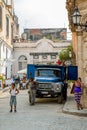 Havana / Cuba - 04.16.2015: Local Cuban men and woman standing on the street in front of an old blue truck Royalty Free Stock Photo