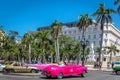 Havana, Cuba - Mar 10th 2018 - Amazing pink car driving through a touristic area of Havana, Cuba