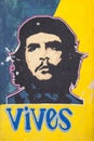 Colorful graffiti of portrait of the face of Ernesto `Che` Guevara with text `you live` on old wall in the city of Havana, Cub