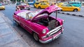 Havana, Cuba - May 02, 2019: pink Chevrolet convertible classic car. repair of taxi in the street.