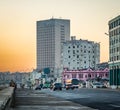 HAVANA, CUBA-OCT 26- Cuban people and cars walk down harborfront of Havana, Cuba at sunrise on October 26 2015 Royalty Free Stock Photo