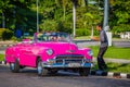 HAVANA, CUBA-OCT 25- Tourist enjoys a photo op in an antique cars used as taxis in Havana, on October 25, 2015