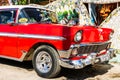 Red classic American car on the streets of Havana, tourist attraction Royalty Free Stock Photo