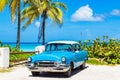 American blue white vintage car parked on the beach in Varadero Cuba -Serie Cuba Reportage