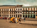 Havana, Cuba - September 2019: Vintage car and colonial houses build next to each other. Bright colour facade and vintage taxi