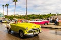 Yellow classic American car on the streets of Havana, tourist attraction Royalty Free Stock Photo