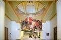 Havana / Cuba - 04.15.2015: Young Cuban girls and boys sitting on the stairs of an art gallery, under a giant colorful artwork