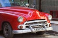 Havana, front of red, old American car Royalty Free Stock Photo