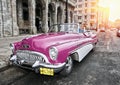 HAVANA- JANUARY 27, 2013: The beautiful woman at a wheel old American retro car 50th years of the last century, an iconic sight