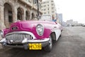 HAVANA- JANUARY 27, 2013: The beautiful woman at a wheel old American retro car 50th years of the last century, an iconic sight Royalty Free Stock Photo