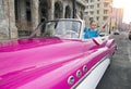 HAVANA- JANUARY 27, 2013: The beautiful woman at a wheel old American retro car 50th years of the last century, an iconic sight Royalty Free Stock Photo