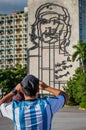 HAVANA - OCTOBER 26- Tourist takes a picture of sculpture of Che Guevara on facade of Ministry of Interior, Plaza de la Revolucio