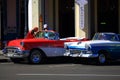 Havana. Red-white and white-blue American old taxi cars on the street