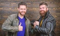 Have agreed. Brutal bearded men wear leather jackets shaking hands. Strong handshake. Friendship of brutal guys