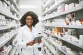 We have all the medication anybody would ever need. Portrait of a cheerful young female pharmacist standing with a Royalty Free Stock Photo