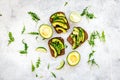 Have a bite with healthy snacks. Avocado toast on grey background top view Royalty Free Stock Photo