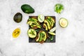 Have a bite with healthy snacks. Avocado toast on grey background top view Royalty Free Stock Photo