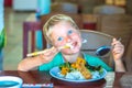 Have a break. Vegetarian food can be delicious for everybody. Boy eat rice and stew vegetables in white plate with Royalty Free Stock Photo