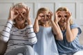 Grandma, mom and girl preschooler posing showing funny fake glasses