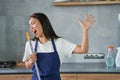 Have fun. Portrait of joyful young woman, cleaning lady pretending to sing, holding broom while cleaning the floor Royalty Free Stock Photo